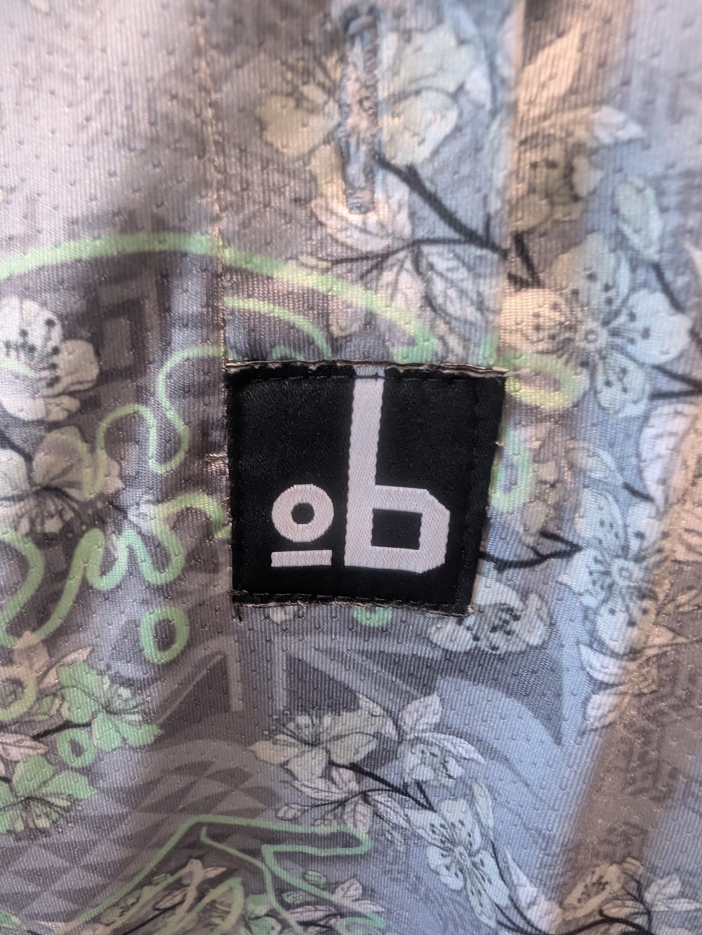 Women's OB Golf Hawaii Grey Floral-Print Polo with Subtle Green Accents - Picture 3 of 3